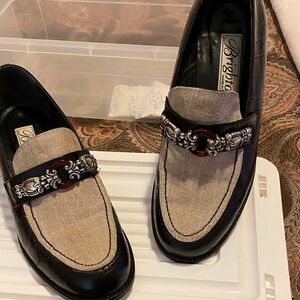 Brighton women’s Black and Cream Slip-On Loafers. The top is a fabric.